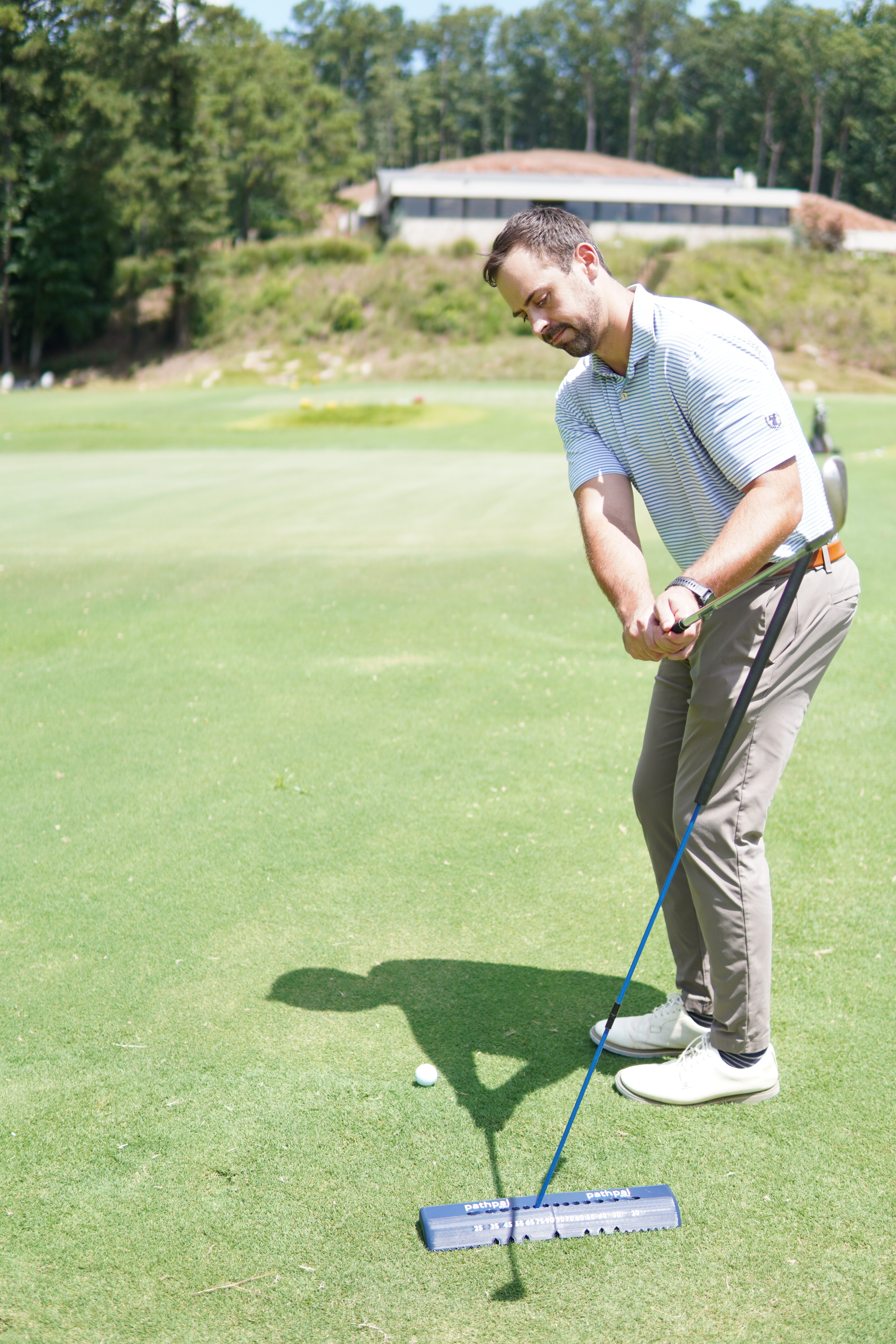 Golfer using pathpal for chipping practice at steep angle