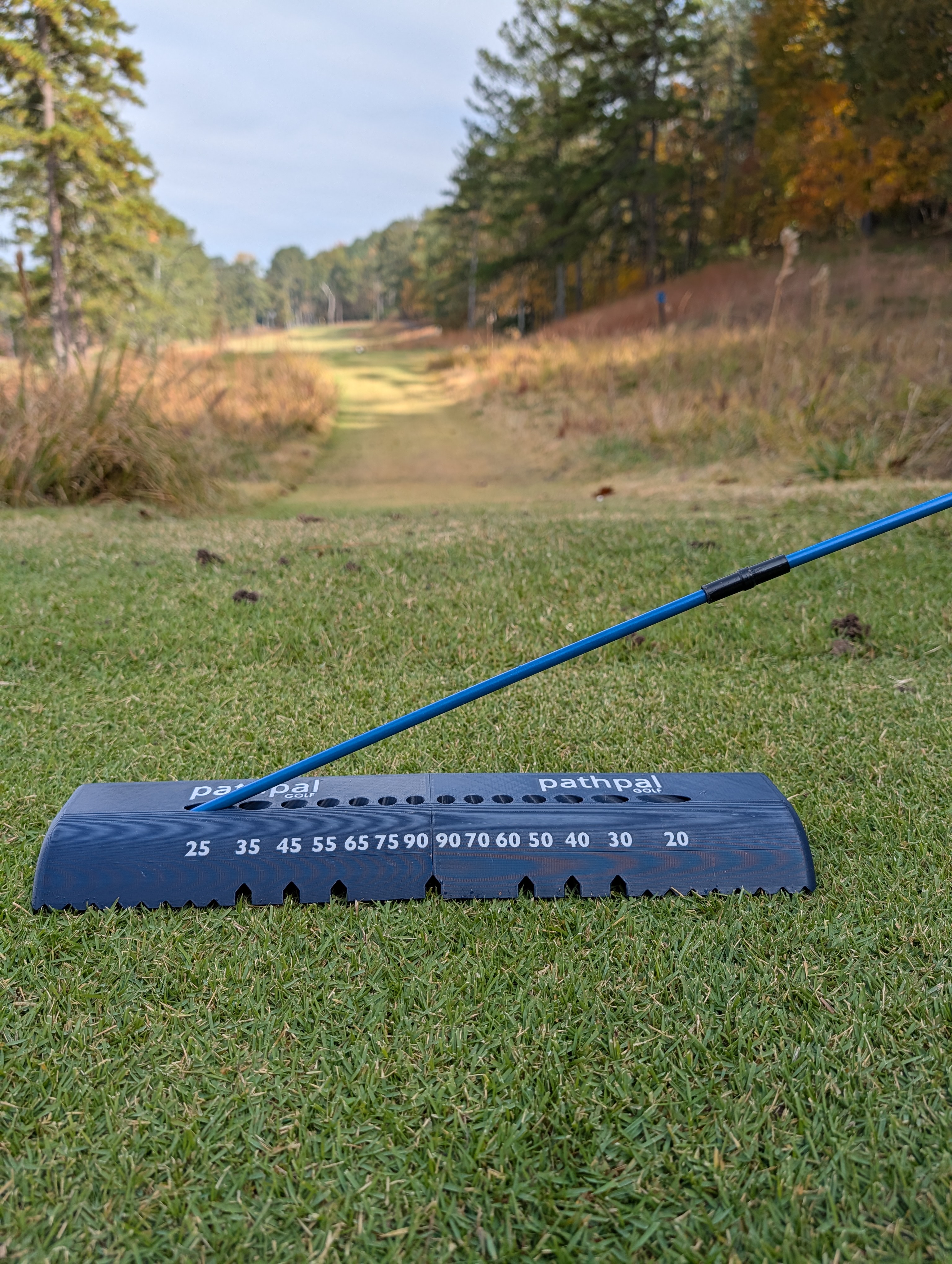 Pathpal Golf training aid on golf course with alignment stick