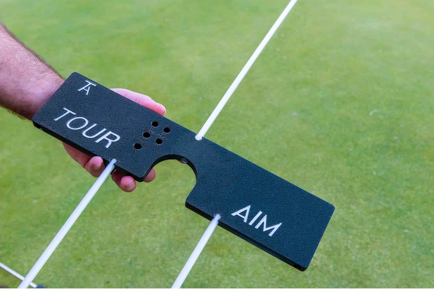 Tour Aim 2.0 being held with alignment sticks inserted
