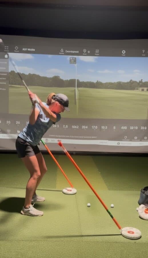 Golfer demonstrating swing path with WhyGolf discs